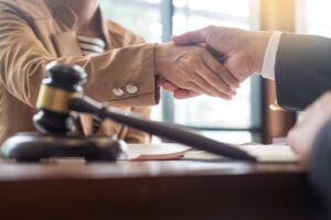 Handshake after cooperation between attorneys lawyer and clients after consultation